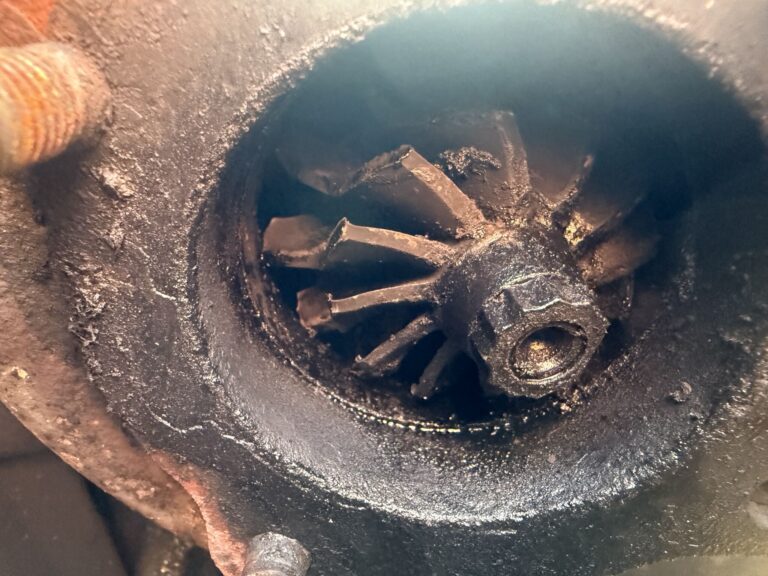 Close-up of a rusty and worn turbocharger turbine wheel